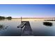A private dock on a tranquil lake, perfect for fishing or enjoying the stunning sunset views at 13562 S Lake Mary Jane Rd, Orlando, FL 32832