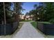 Long driveway with a gated entrance leading to a charming two-story home at 13562 S Lake Mary Jane Rd, Orlando, FL 32832