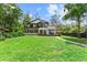 A modern home with a large backyard, featuring a spacious deck and manicured lawn at 13562 S Lake Mary Jane Rd, Orlando, FL 32832