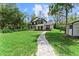 Charming two-story home with a lush green lawn and inviting stone walkway at 13562 S Lake Mary Jane Rd, Orlando, FL 32832