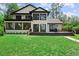 Exterior view of a stunning home with a large backyard, perfect for outdoor enjoyment and relaxation at 13562 S Lake Mary Jane Rd, Orlando, FL 32832
