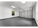 Spacious garage with white walls, gray epoxy floors, and a large sectional door, offering ample parking and storage space at 13562 S Lake Mary Jane Rd, Orlando, FL 32832