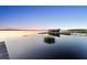 Picturesque boathouse and dock on a tranquil lake, offering a peaceful waterfront lifestyle at 13562 S Lake Mary Jane Rd, Orlando, FL 32832