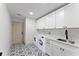 Modern laundry room features sleek cabinetry, stylish flooring, and updated appliances for easy living at 13562 S Lake Mary Jane Rd, Orlando, FL 32832