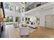 Bright living room with an open floor plan with large windows and comfortable seating at 13562 S Lake Mary Jane Rd, Orlando, FL 32832