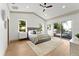 Tranquil main bedroom showcasing sliding glass doors that lead to a deck with views of the serene lake at 13562 S Lake Mary Jane Rd, Orlando, FL 32832