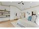 Bright main bedroom featuring tray ceilings, wood floors, decorative shelving, and access to the en suite bath at 13562 S Lake Mary Jane Rd, Orlando, FL 32832