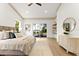 Bright main bedroom featuring tray ceilings, wood floors, and sliding glass doors with views of the serene lake at 13562 S Lake Mary Jane Rd, Orlando, FL 32832