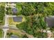 An aerial view of a home with mature landscaping and a spacious yard next to a lake at 16500 Magnolia Terrace Blvd, Montverde, FL 34756