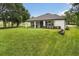 Expansive backyard featuring a covered patio with a built-in grill, perfect for outdoor entertaining at 16500 Magnolia Terrace Blvd, Montverde, FL 34756