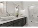 Elegant bathroom featuring a double vanity with vessel sinks, marble countertops, and a luxurious walk-in shower at 16500 Magnolia Terrace Blvd, Montverde, FL 34756