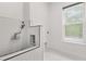 This bathroom features a dog washing station and a bright window for natural light at 16500 Magnolia Terrace Blvd, Montverde, FL 34756