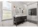 Modern bathroom with double vanity, vessel sinks, sleek black hardware, and a glass-enclosed shower at 16500 Magnolia Terrace Blvd, Montverde, FL 34756