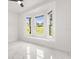 Bright bedroom with a large window and modern tile flooring, offering a serene and inviting space at 16500 Magnolia Terrace Blvd, Montverde, FL 34756