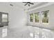 Bright bedroom with three large windows offering outdoor views and stylish modern tile flooring at 16500 Magnolia Terrace Blvd, Montverde, FL 34756