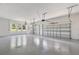 This is a spacious garage with two garage doors and windows for natural light at 16500 Magnolia Terrace Blvd, Montverde, FL 34756