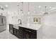 Kitchen island with a large, single bowl sink, stainless steel dishwasher, and stylish gold hardware at 16500 Magnolia Terrace Blvd, Montverde, FL 34756