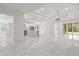 Spacious living area with an open floor plan, marble floors, modern lighting, and bright natural light at 16500 Magnolia Terrace Blvd, Montverde, FL 34756