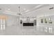 Open floor plan with kitchen island featuring a contrasting black and white design and marble floors at 16500 Magnolia Terrace Blvd, Montverde, FL 34756