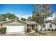 Charming single-story home features an attached garage and well-maintained front yard with mature trees at 236 N Ranger Blvd, Winter Park, FL 32792