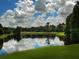 Picturesque golf course with a calm lake reflecting the sky at 236 N Ranger Blvd, Winter Park, FL 32792