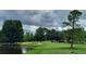 Scenic view of a golf course featuring lush green fairways and a tranquil water hazard at 236 N Ranger Blvd, Winter Park, FL 32792