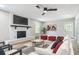 Bright living room features a painted brick fireplace and a stylish ceiling fan at 236 N Ranger Blvd, Winter Park, FL 32792