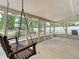 Relaxing sunroom with nature views and a charming swing at 236 N Ranger Blvd, Winter Park, FL 32792