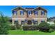Charming two-story home with manicured landscaping and classic architectural details at 3008 Cardillino Way, Kissimmee, FL 34741