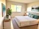 Comfortable bedroom featuring a large window, soft lighting, and decor at 604 Kenwick Cir # 105, Casselberry, FL 32707