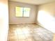 An empty room has tiled floors and a light-filled ambiance at 604 Kenwick Cir # 105, Casselberry, FL 32707