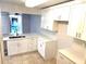Renovated kitchen featuring bright white cabinetry and stainless hardware at 604 Kenwick Cir # 105, Casselberry, FL 32707
