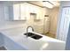 Newly renovated kitchen with white cabinets, stone countertops, and tile floors at 604 Kenwick Cir # 105, Casselberry, FL 32707