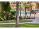 Community pool with seating surrounded by lush, mature palm trees at 604 Kenwick Cir # 105, Casselberry, FL 32707