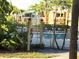 Relaxing community pool area with lounge chairs and lush tropical landscaping at 604 Kenwick Cir # 105, Casselberry, FL 32707
