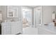 Elegant bathroom featuring marble countertops, white cabinetry, and a classic freestanding tub at 690 E Church St, Bartow, FL 33830