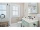 Bathroom with glass shower, light blue vanity, and natural light at 690 E Church St, Bartow, FL 33830