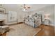 Bright bedroom with hardwood floors, white trim, ornate ceiling fan, and decorative wrought iron bed frame at 690 E Church St, Bartow, FL 33830