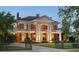 Stately brick home with classic architectural details, towering columns, and a beautifully landscaped front yard at 690 E Church St, Bartow, FL 33830