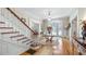 Inviting foyer featuring hardwood floors, a staircase, and elegant lighting at 690 E Church St, Bartow, FL 33830