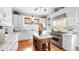Bright kitchen with white cabinetry, a marble countertop island, and hardwood floors at 690 E Church St, Bartow, FL 33830