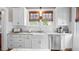 Stylish kitchen featuring white cabinets, marble countertops, and stainless steel appliances at 690 E Church St, Bartow, FL 33830