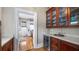 The butler's pantry features a wine fridge, glass cabinets, and marble countertops at 690 E Church St, Bartow, FL 33830