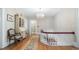 Second floor landing with hardwood floors, chandelier, and vintage furniture at 690 E Church St, Bartow, FL 33830