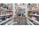 Organized walk-in pantry with white shelves, countertop, microwave, and curtained storage at 690 E Church St, Bartow, FL 33830