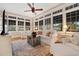 Bright sunroom with large windows, white furniture, and a decorative area rug at 690 E Church St, Bartow, FL 33830