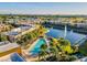 A scenic aerial view showcases a community pool, lake with fountain, and surrounding residences at 7672 Amazonas St, Kissimmee, FL 34747