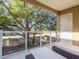 Spacious outdoor balcony with seating, a view of a big tree, and privacy glass at 7672 Amazonas St, Kissimmee, FL 34747