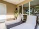 Relaxing outdoor balcony with comfortable lounge chairs and lush green views at 7672 Amazonas St, Kissimmee, FL 34747