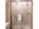 Bathroom with sliding glass door shower and tiled walls at 7672 Amazonas St, Kissimmee, FL 34747